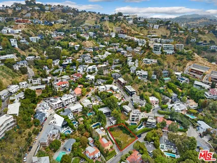 an aerial view of residential houses with city view