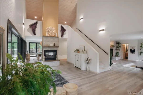 a view of a livingroom with furniture and staircase