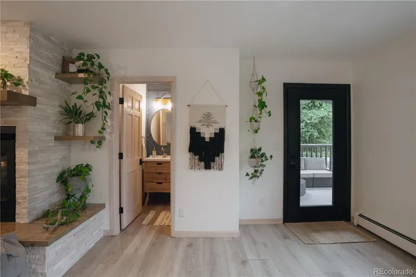 a view of a hallway view with wooden floor and a potted plant