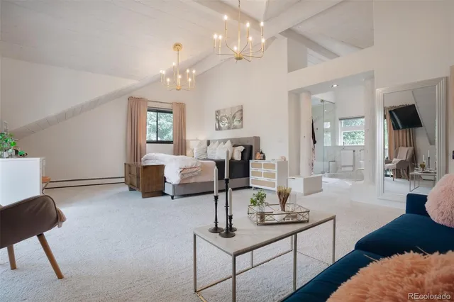 a living room with furniture a chandelier and a flat screen tv