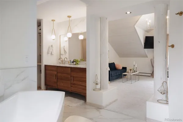 a en suite bathroom with a double vanity sink and a mirror