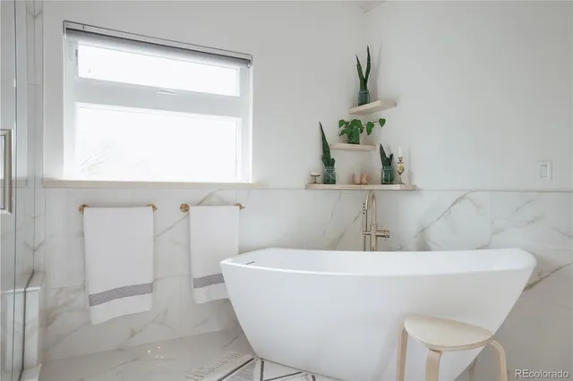 a white bath tub sitting next to a window