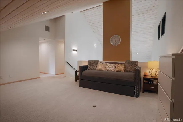 a living room with furniture and a wall painting