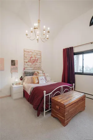 a spacious bedroom with a bed and window