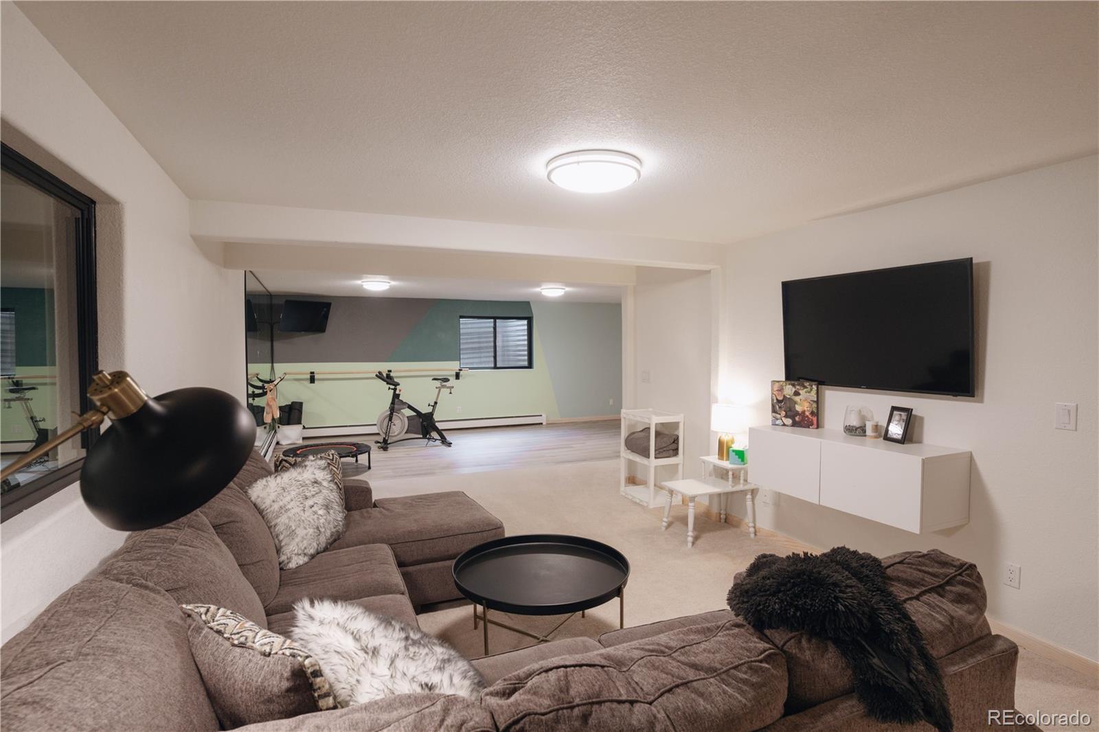 1709 Red Hawk Road Silverthorne, CO 80498 - Photo 38 of 50 a living room with furniture and a flat screen tv