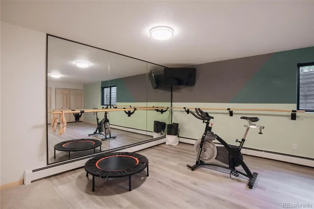 a room with gym equipment and air hockey table