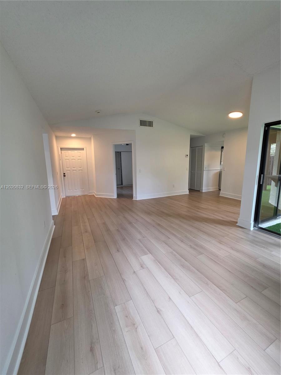 15240 Southwest 45th Terrace, Unit 54F Miami, FL 33185 - Photo 17 of 48 a view of a big room with wooden floor and windows