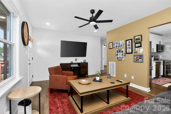 a living room with furniture a rug and a flat screen tv