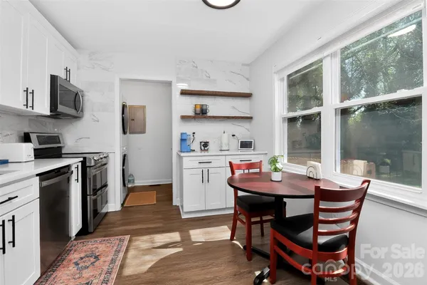 a view of a dining room with furniture and wooden floor