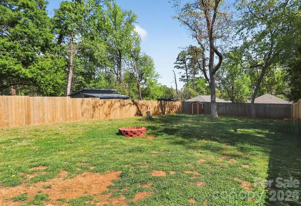 a view of a backyard with a tree