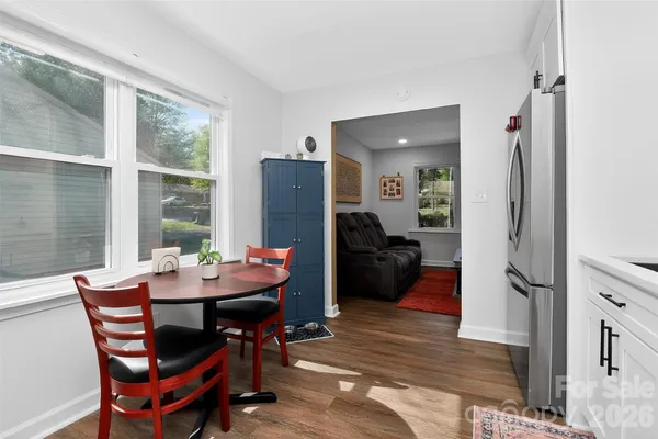 a dining room with furniture and a floor to ceiling window