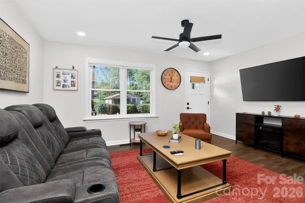 a living room with furniture and a flat screen tv