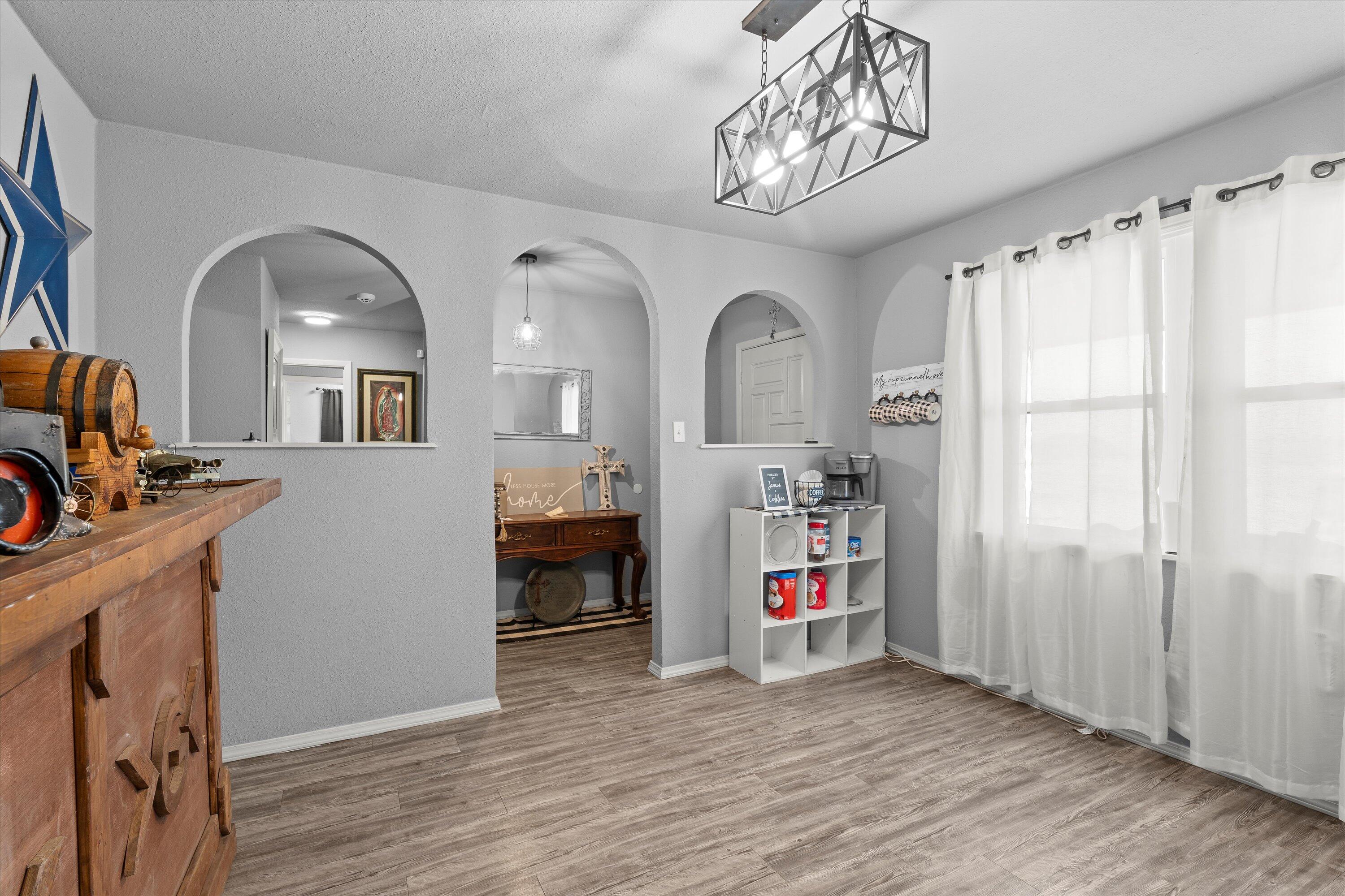 3718 South State Road, Unit 303 Sundown, TX 79372 - Photo 11 of 23 a view of a livingroom with a furniture hardwood floor and a view of living room