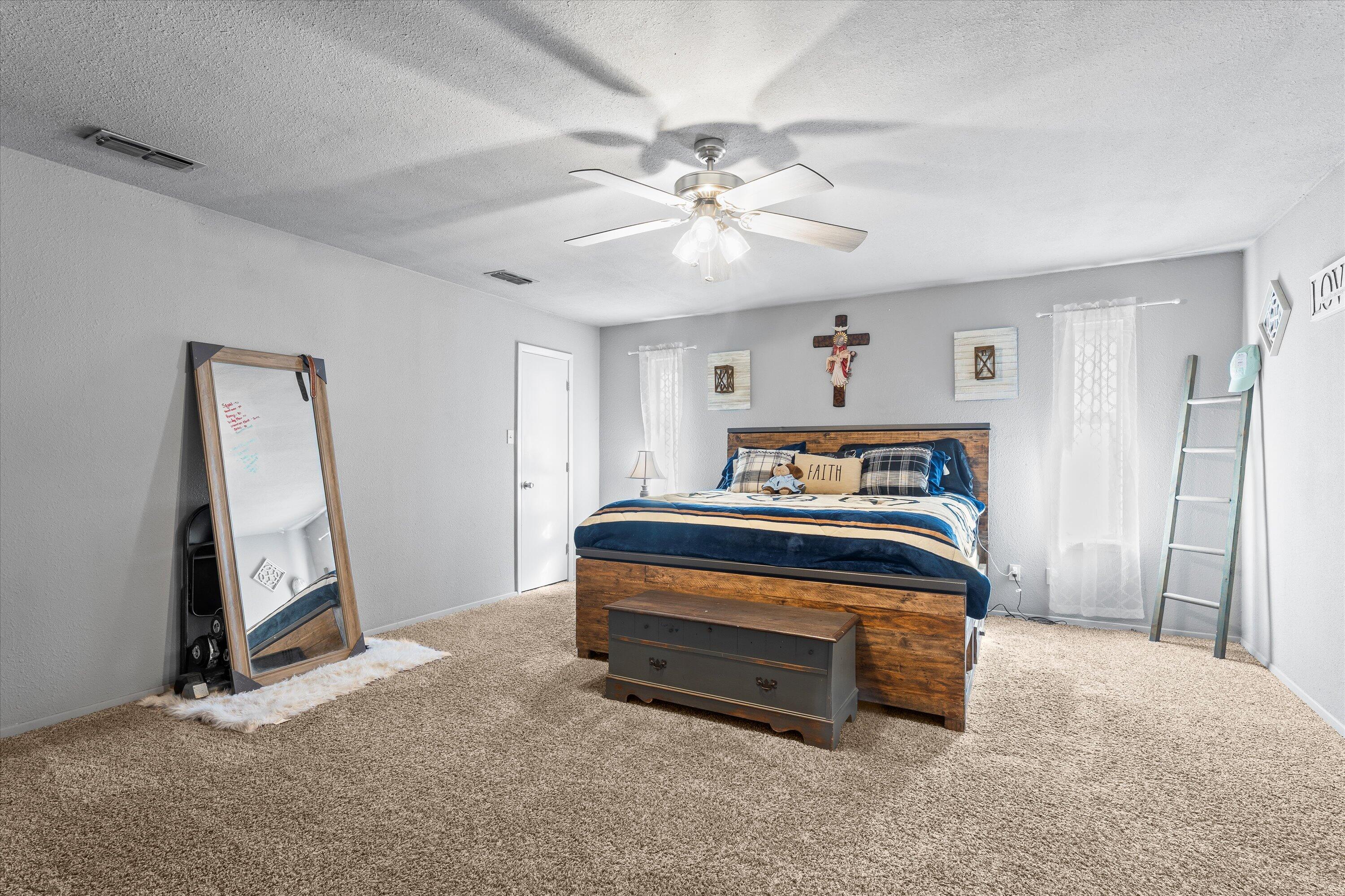 3718 South State Road, Unit 303 Sundown, TX 79372 - Photo 12 of 23 a bedroom with a bed and a mirror