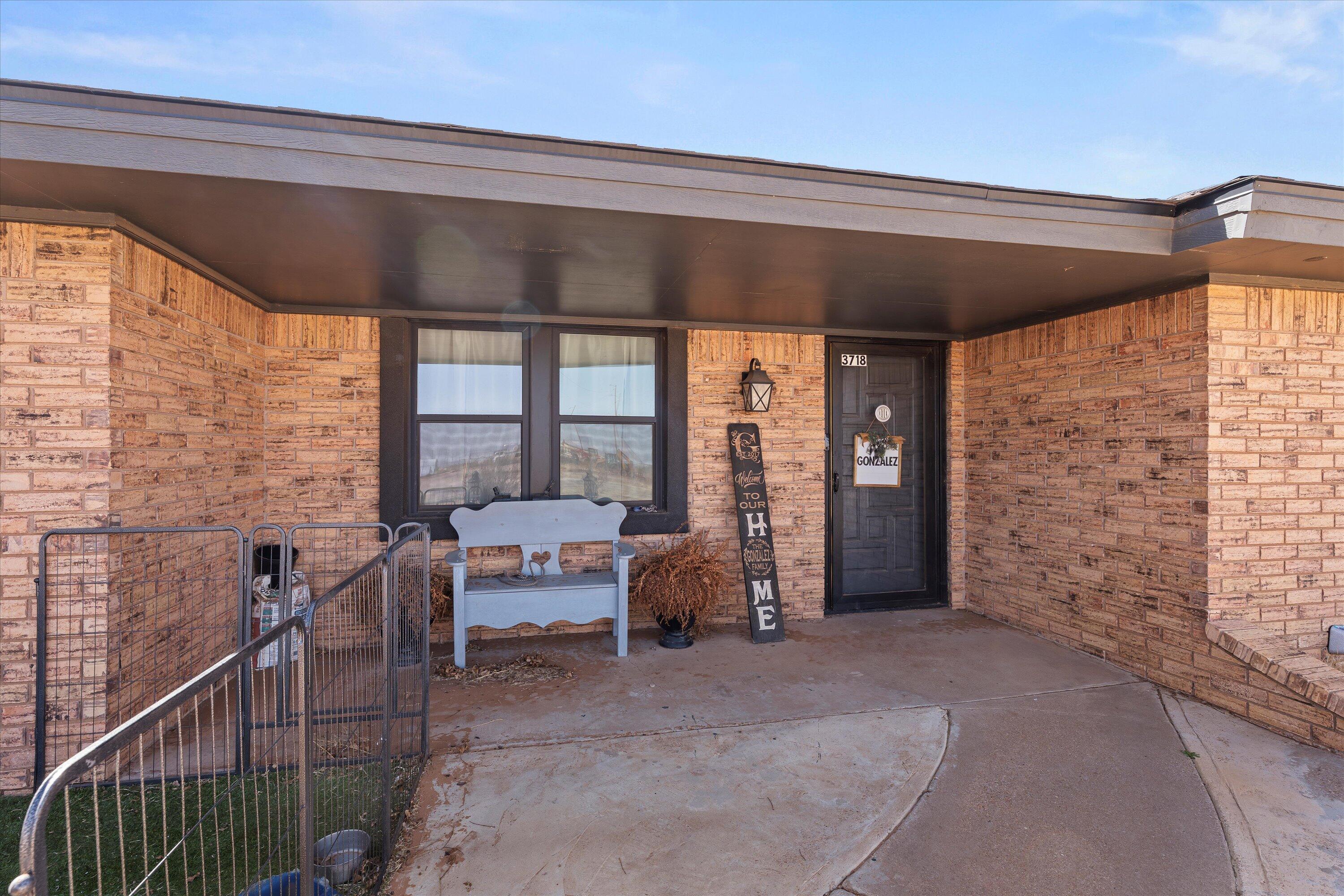 3718 South State Road, Unit 303 Sundown, TX 79372 - Photo 2 of 23 a living room with furniture and a gate
