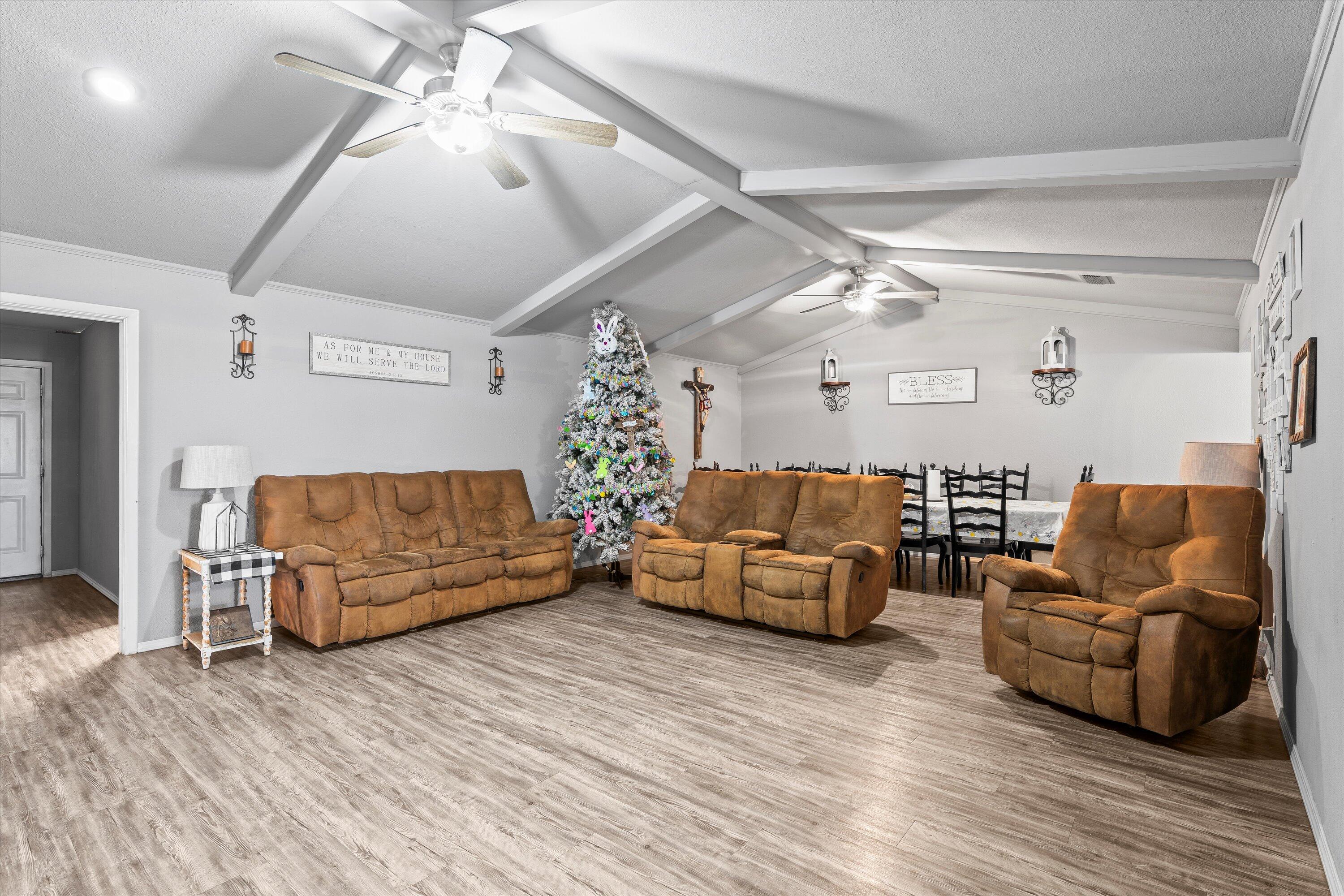 3718 South State Road, Unit 303 Sundown, TX 79372 - Photo 5 of 23 a living room with furniture and wooden floor