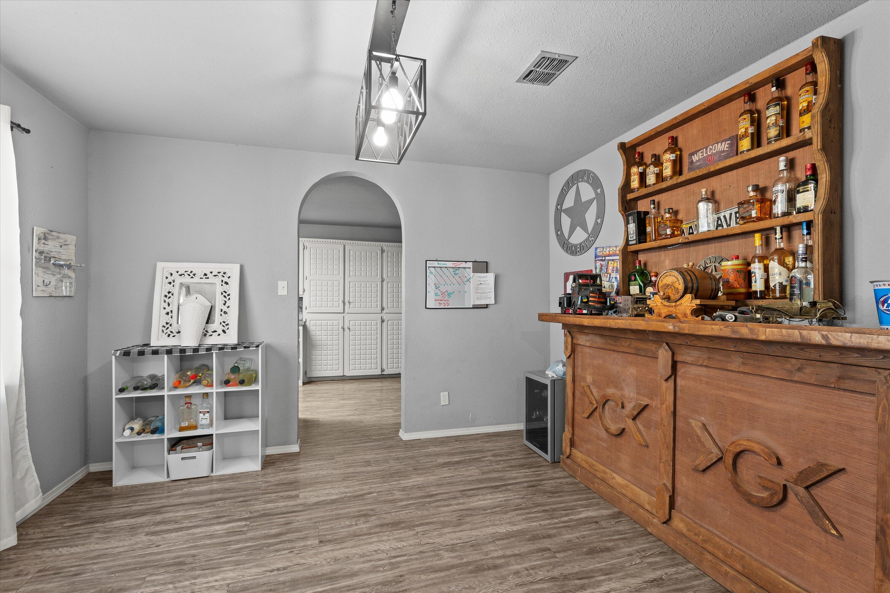3718 South State Road, Unit 303 Sundown, TX 79372 - Photo 10 of 23 a view of a hallway with wooden floor and entryway