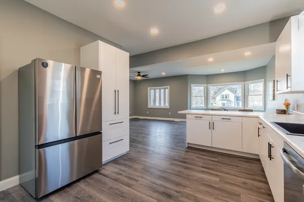a kitchen with stainless steel appliances a refrigerator sink and cabinets
