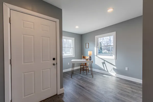 wooden floor in an empty room with a window