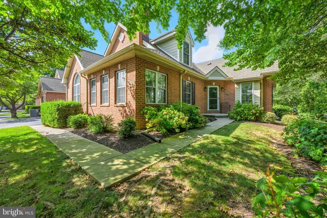 a front view of house with yard and trees around