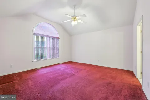 a view of empty room with a chandelier fan