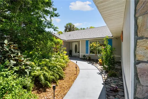 a view of a house with potted plants