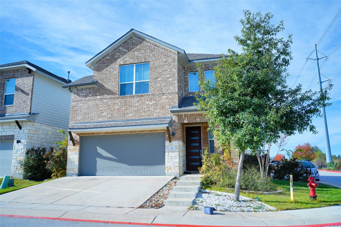 900 Old Mill Road, Unit 33 Cedar Park, TX 78613 - Photo 1 of 1 a front view of a house with a garden