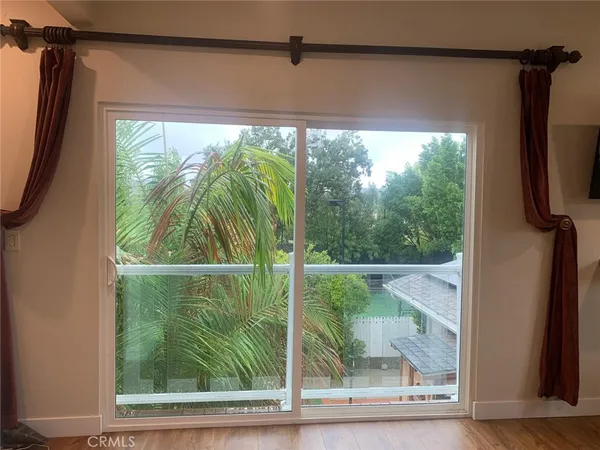 a view of a glass door with a yard
