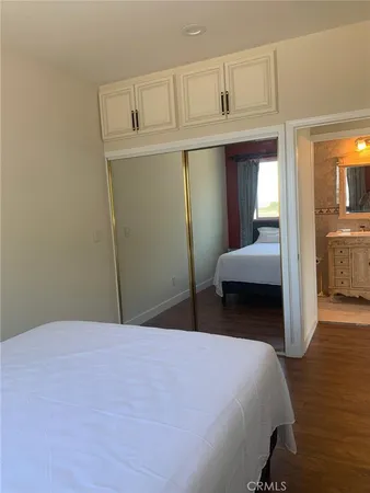 a bedroom with a bed and a mirror