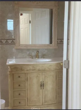 a bathroom with a sink vanity and a mirror