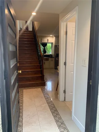 a view of entryway and hall with wooden floor