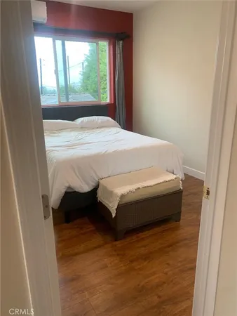 a bed sitting in a bedroom next to a window