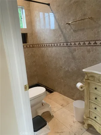 a bathroom with a toilet and a shower