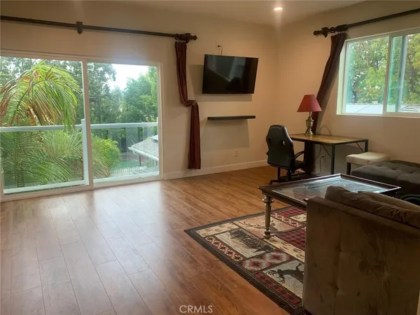 a room with wooden floor and a window