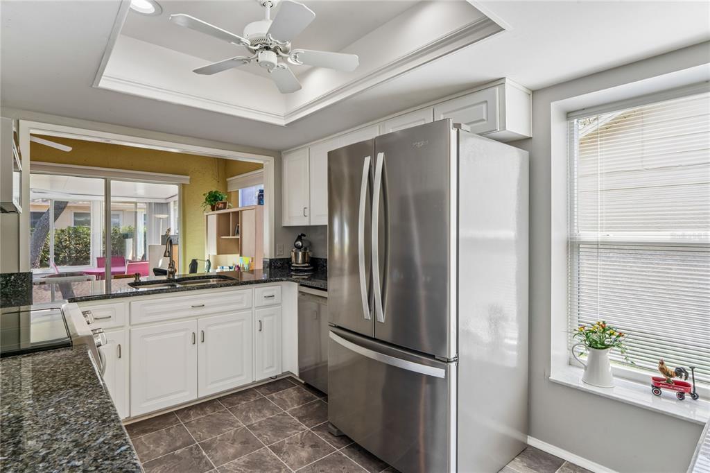 2252 Pebble Beach Drive Spring Hill, FL 34606 - Photo 11 of 100 a kitchen with stainless steel appliances a refrigerator sink and stove