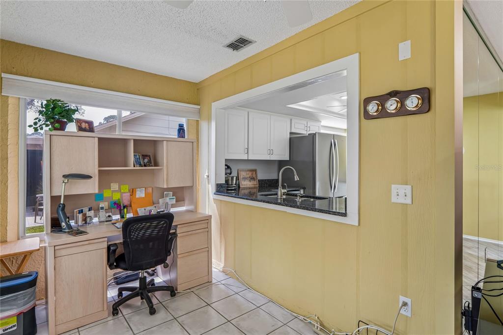 2252 Pebble Beach Drive Spring Hill, FL 34606 - Photo 15 of 100 a kitchen with stainless steel appliances granite countertop a refrigerator and a stove top oven