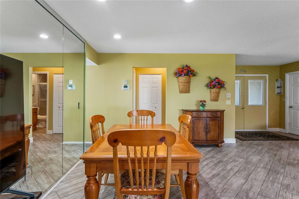 2252 Pebble Beach Drive Spring Hill, FL 34606 - Photo 16 of 100 a view of a dining room with furniture and wooden floor