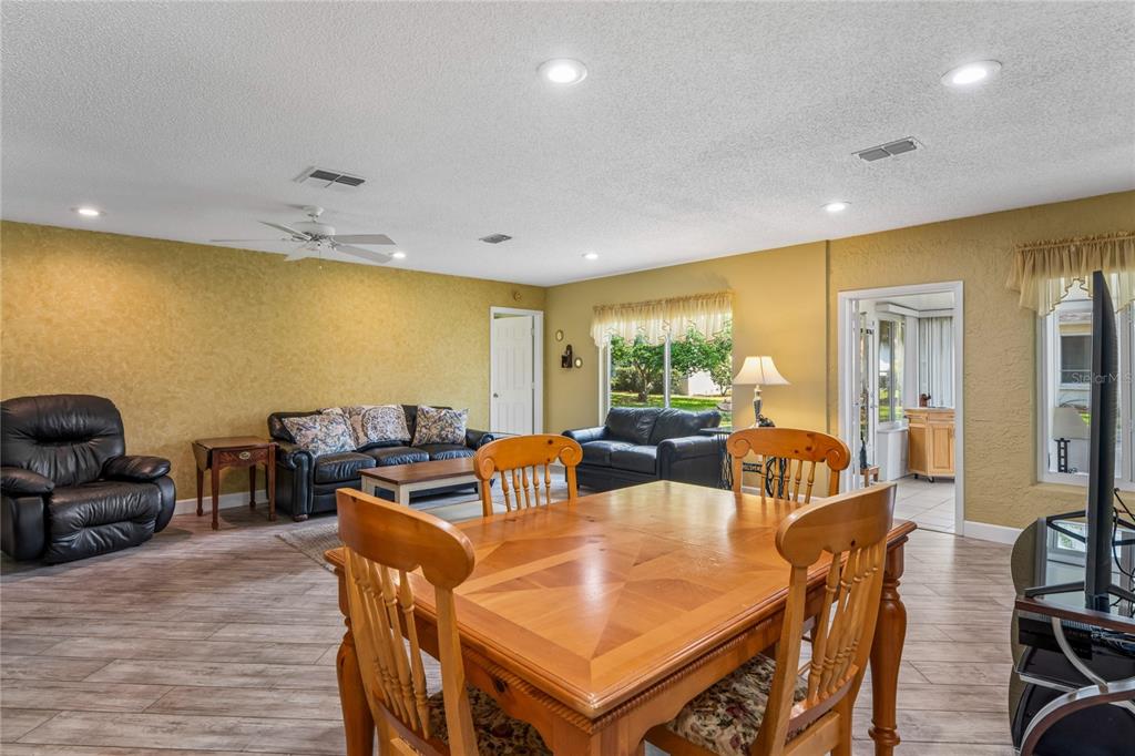 2252 Pebble Beach Drive Spring Hill, FL 34606 - Photo 17 of 100 a living room with furniture a flat screen tv and a large window