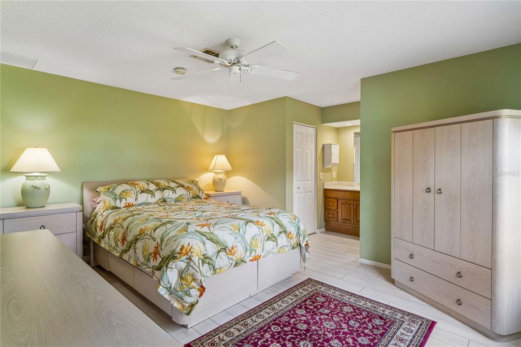 2252 Pebble Beach Drive Spring Hill, FL 34606 - Photo 19 of 100 a bedroom with a bed and a chandelier