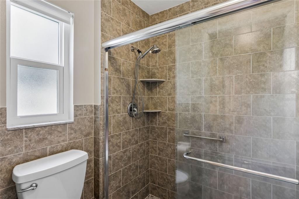 2252 Pebble Beach Drive Spring Hill, FL 34606 - Photo 23 of 100 a bathroom with a shower a toilet and a sink