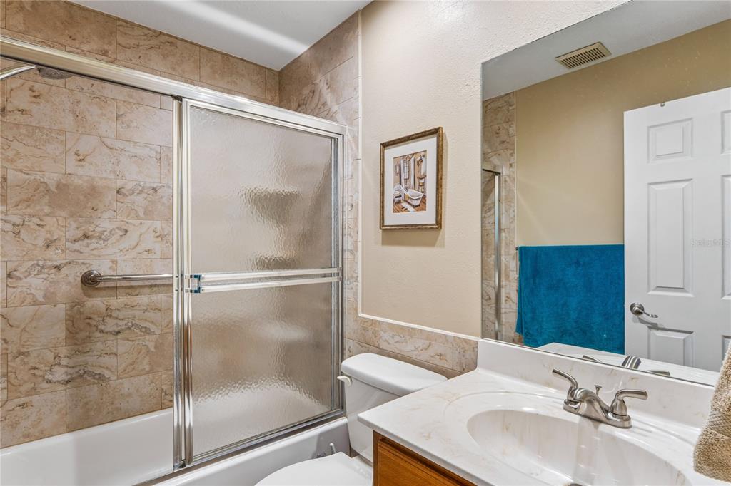2252 Pebble Beach Drive Spring Hill, FL 34606 - Photo 27 of 100 a bathroom with a sink and a mirror