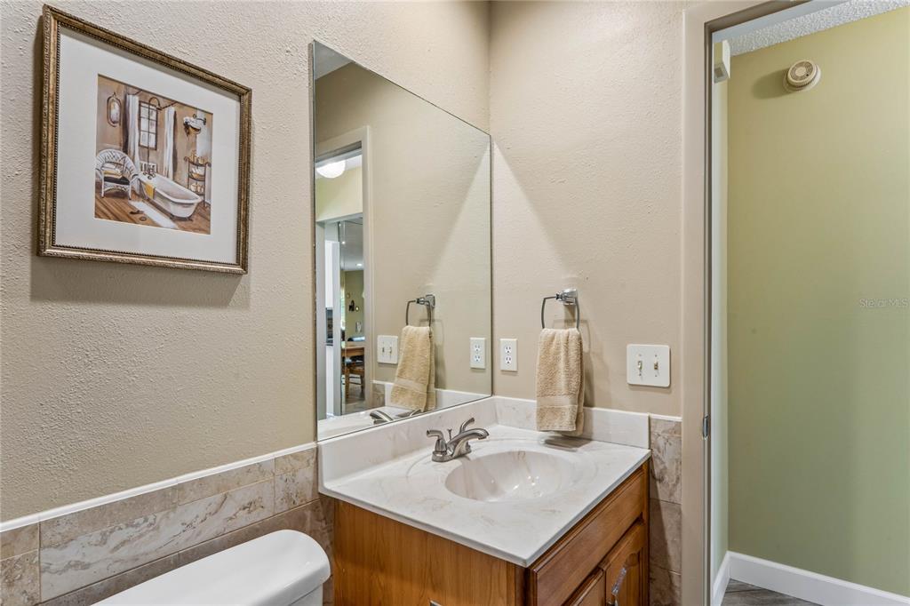 2252 Pebble Beach Drive Spring Hill, FL 34606 - Photo 29 of 100 a bathroom with a sink and a mirror