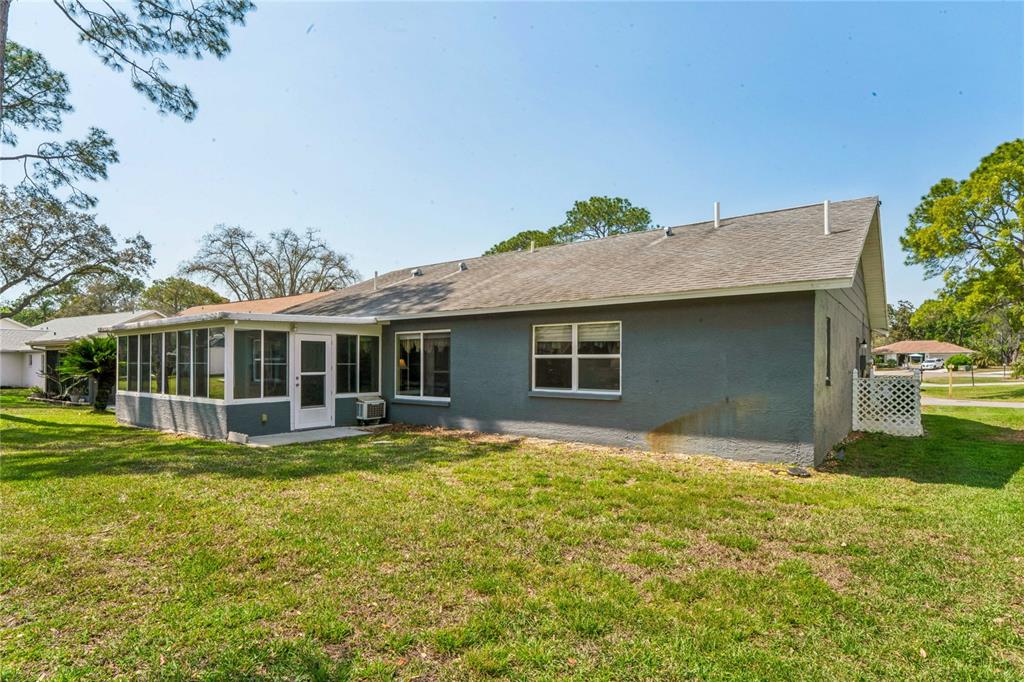 2252 Pebble Beach Drive Spring Hill, FL 34606 - Photo 33 of 100 a view of a house with a yard and sitting area