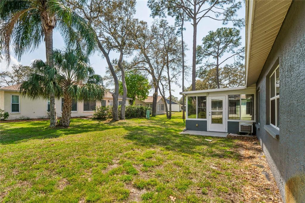 2252 Pebble Beach Drive Spring Hill, FL 34606 - Photo 34 of 100 a view of a house with a yard and potted plants