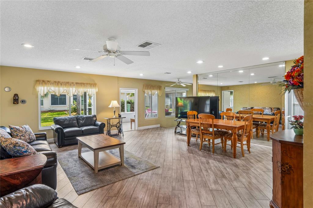 2252 Pebble Beach Drive Spring Hill, FL 34606 - Photo 6 of 100 a living room with furniture and a wooden floor