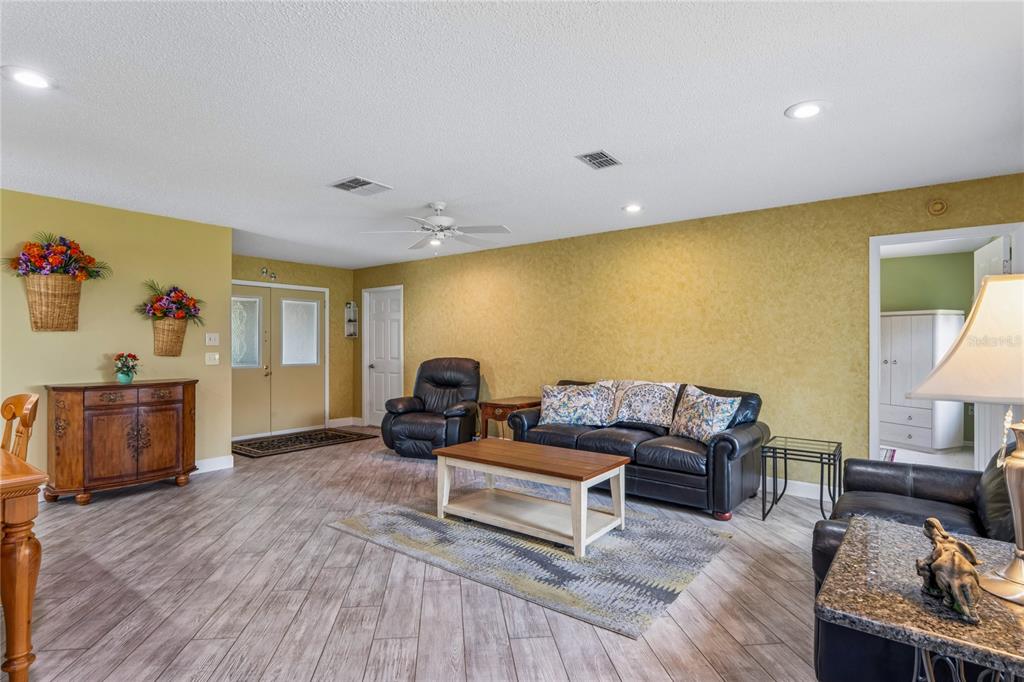 2252 Pebble Beach Drive Spring Hill, FL 34606 - Photo 9 of 100 a living room with furniture and a wooden floor