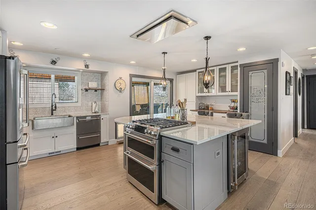 a kitchen with stainless steel appliances granite countertop a stove and a refrigerator