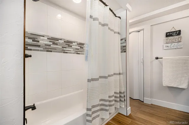 a bathroom with a shower and a glass door