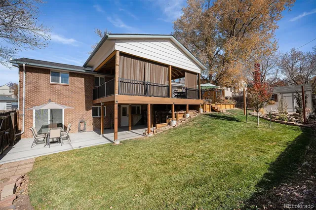 a view of a house with a yard patio and fire pit