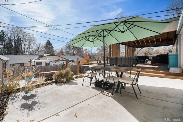 a view of a tables and chairs under an umbrella